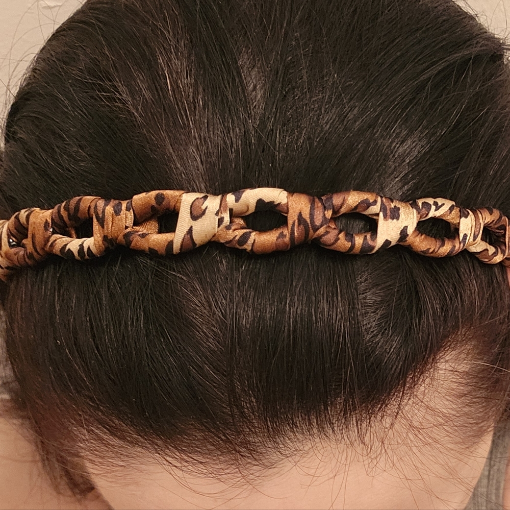 Silky Leopard Print Fabric Wrapped Headband with Almond Shaped Cutouts.